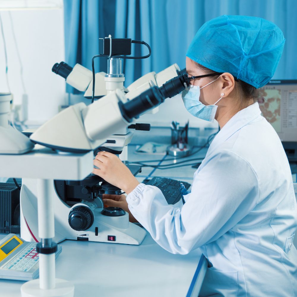 Scientist working with a microscope in a laboratory